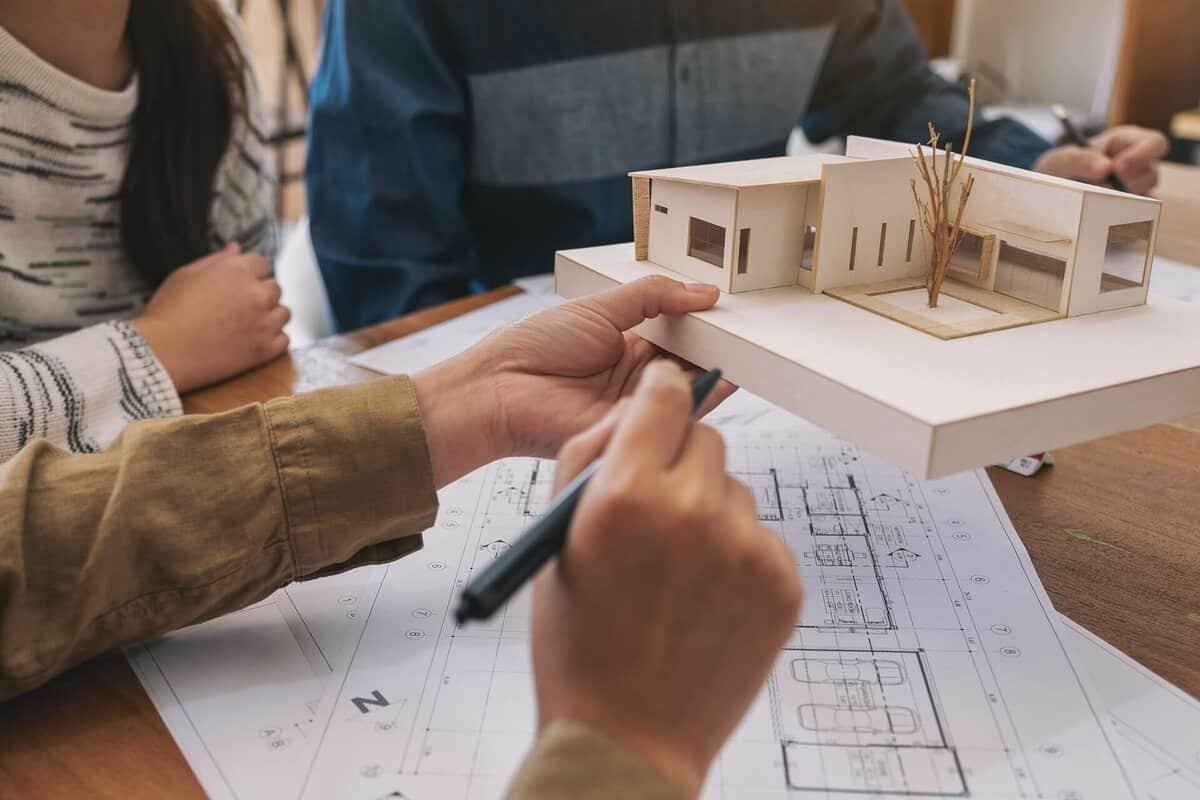 Architectural model and blueprint for a modern building project.